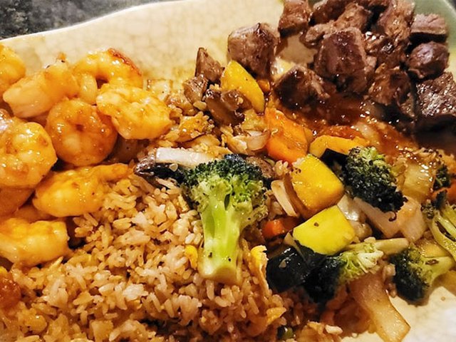 Hibachi shrimp and steak with fried rice and grilled vegetables.